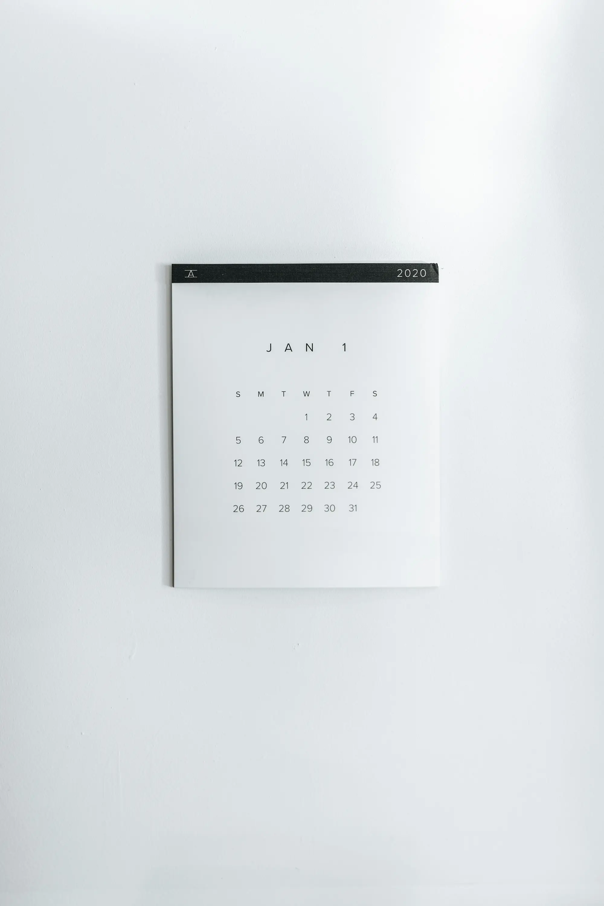 White wall calendar showing the month grid.